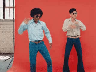 A GIF of two men disco dancing