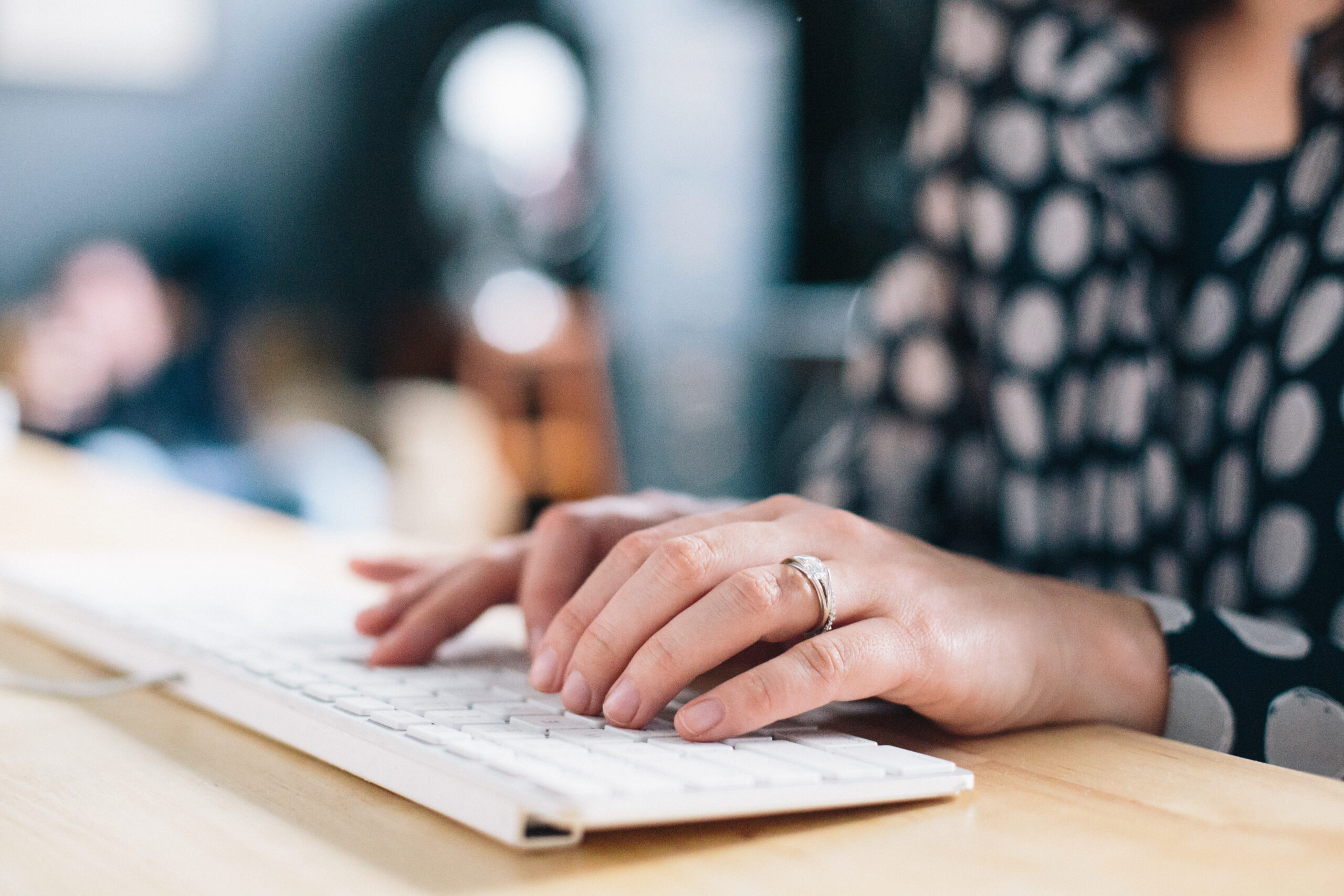 Image of a woman typing on a computer 
