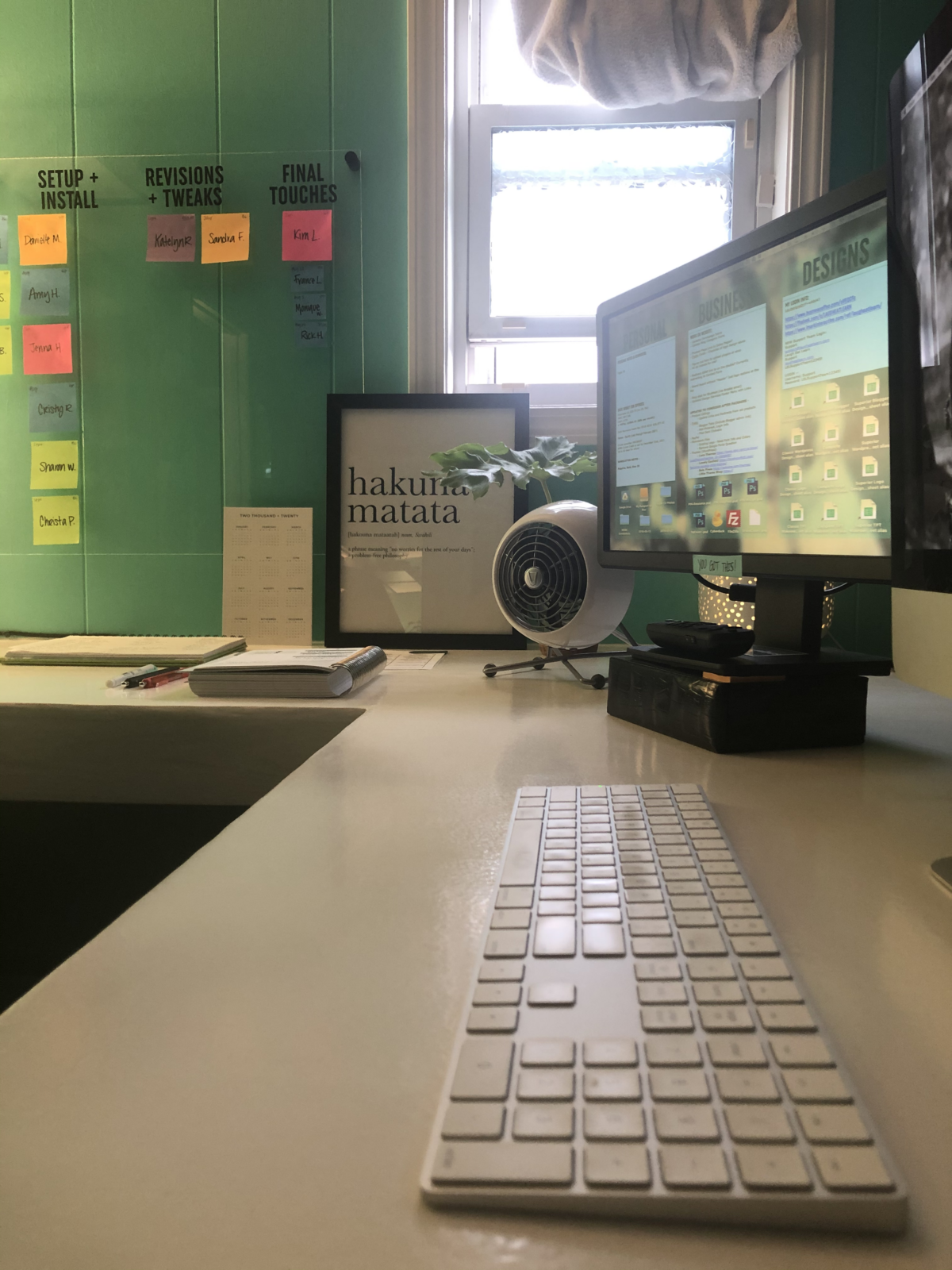 My home office setup with a keyboard, computer, and fan